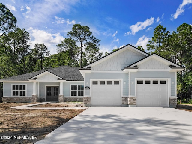 craftsman inspired home featuring a garage and french doors