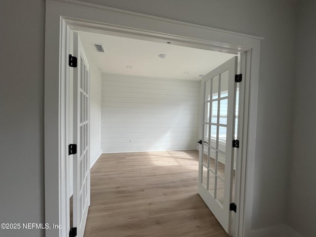 hallway featuring french doors and light wood-type flooring