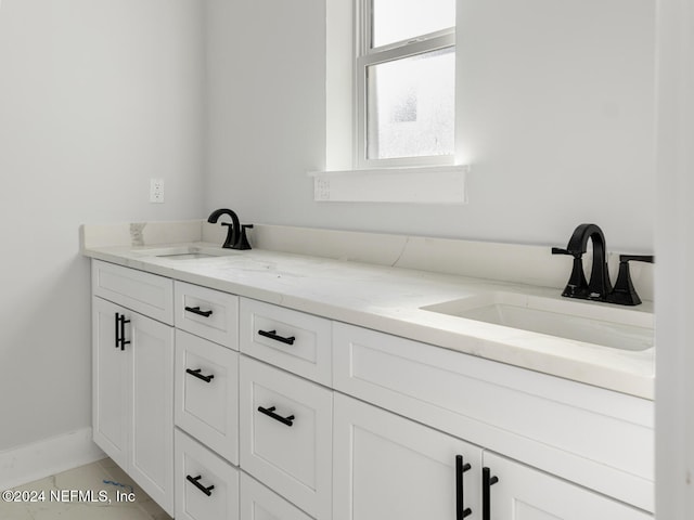 bathroom with tile patterned flooring and vanity