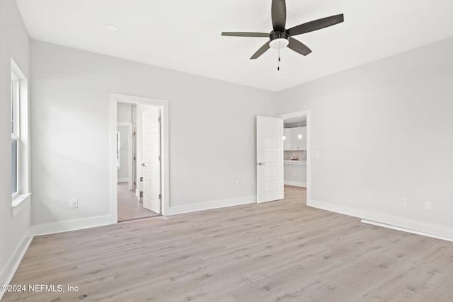 unfurnished bedroom with ceiling fan and light wood-type flooring