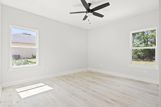 spare room with ceiling fan and light wood-type flooring