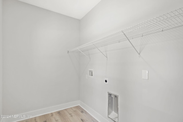 clothes washing area with washer hookup, hardwood / wood-style flooring, and electric dryer hookup