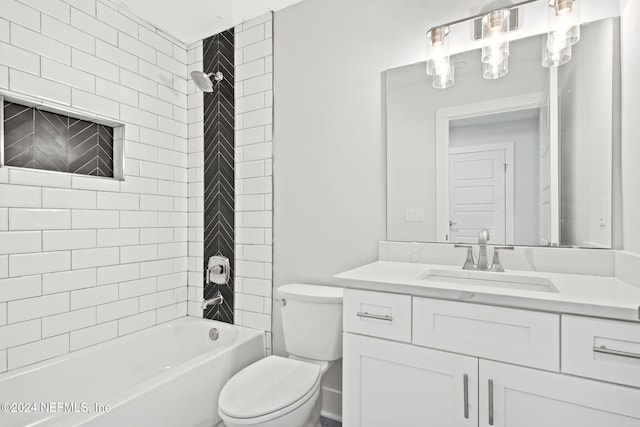 full bathroom featuring vanity, toilet, and tiled shower / bath