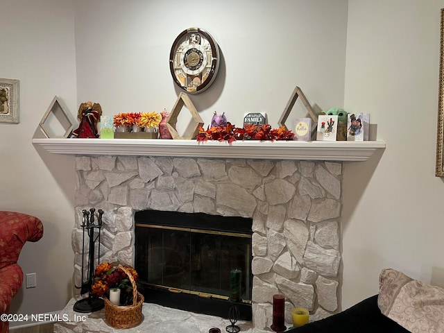 interior details featuring a stone fireplace