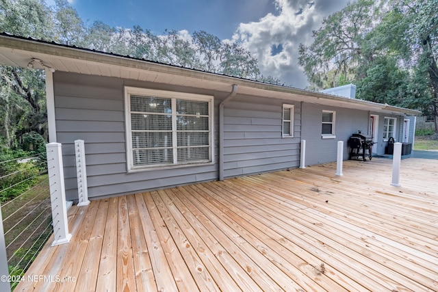 wooden terrace with a grill