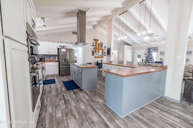 kitchen featuring stainless steel appliances, beam ceiling, white cabinets, a center island, and light hardwood / wood-style floors