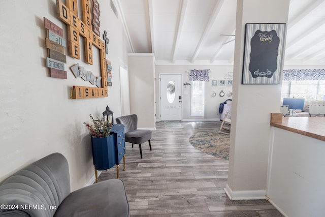 corridor featuring beam ceiling and hardwood / wood-style flooring