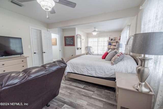 bedroom with ceiling fan and wood-type flooring