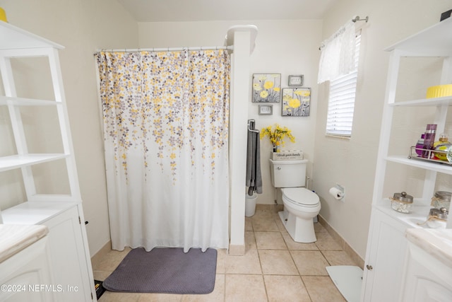 bathroom featuring tile patterned flooring, vanity, curtained shower, and toilet