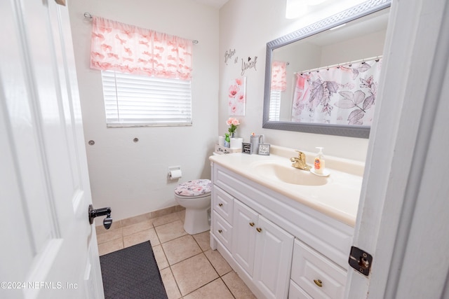 bathroom featuring toilet, vanity, and tile patterned floors