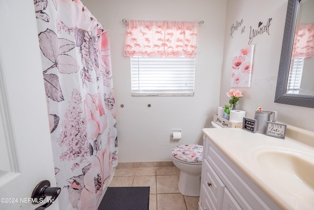 bathroom with tile patterned flooring, a shower with curtain, vanity, and toilet