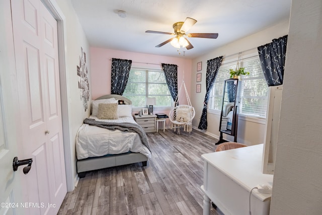 bedroom featuring ceiling fan, wood-type flooring, and a closet