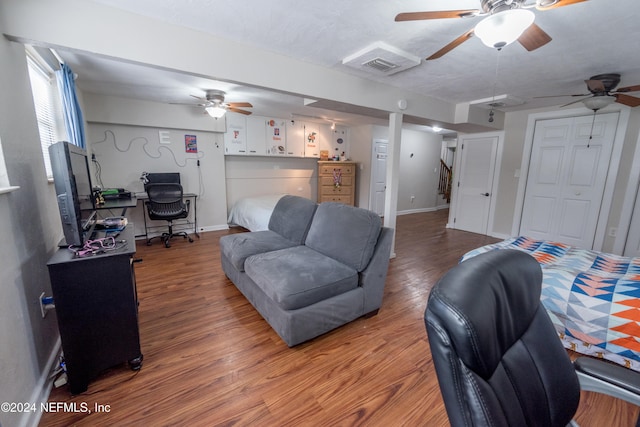 living room with ceiling fan and wood-type flooring