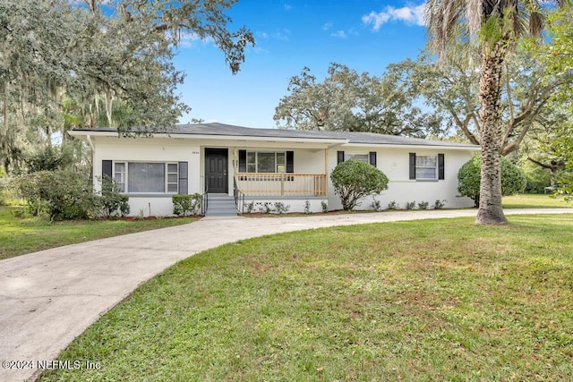 single story home with covered porch and a front yard