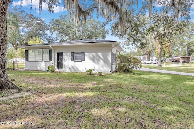 back of property featuring a lawn