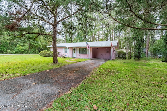 single story home with a front yard and a carport