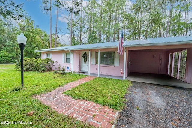 ranch-style house with a carport and a front lawn