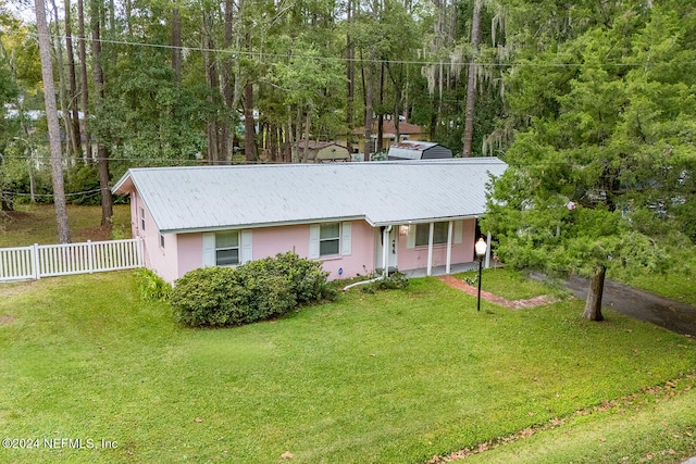 ranch-style house with a porch and a front lawn