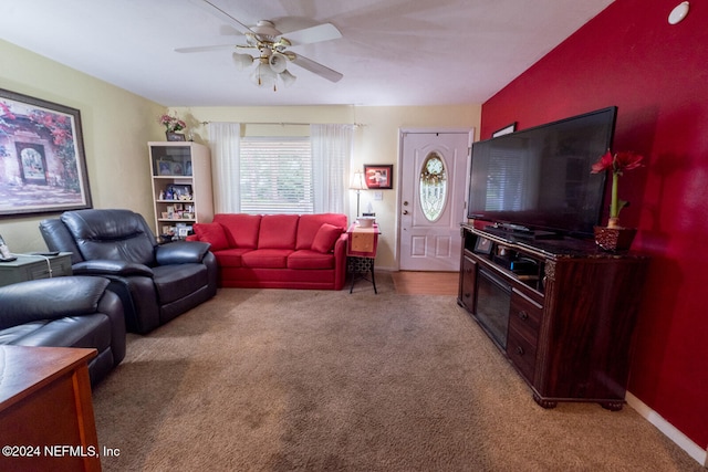 living room with ceiling fan, light colored carpet, and lofted ceiling