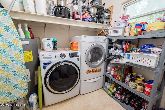 washroom with separate washer and dryer and water heater