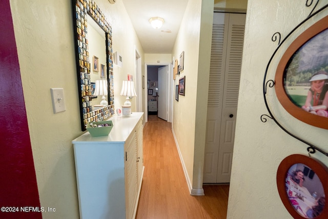 hall with light hardwood / wood-style flooring