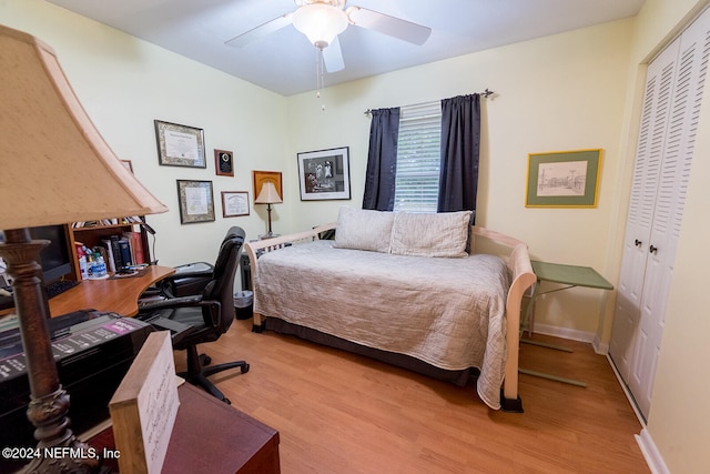 bedroom with light hardwood / wood-style floors, a closet, and ceiling fan