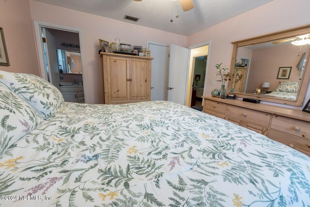 bedroom with ensuite bath and ceiling fan