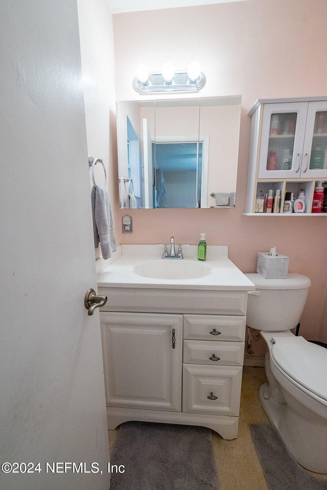 bathroom featuring vanity and toilet