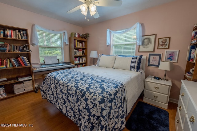 bedroom with light hardwood / wood-style floors, multiple windows, and ceiling fan