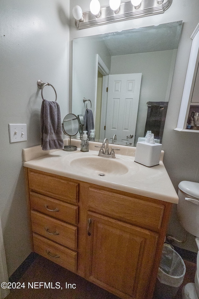 bathroom featuring vanity and toilet