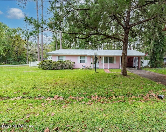 single story home with a front yard and a carport