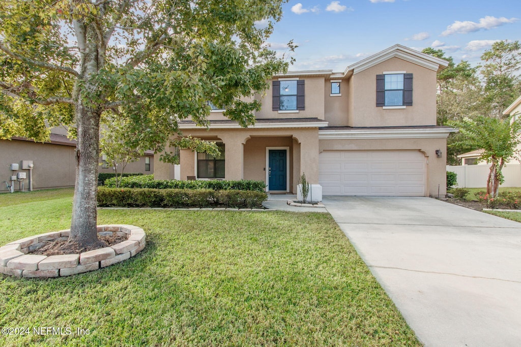 view of front of property with a garage and a front yard