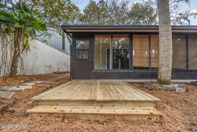 doorway to property with a wooden deck