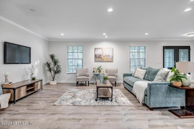 living room featuring french doors, light hardwood / wood-style flooring, and ornamental molding