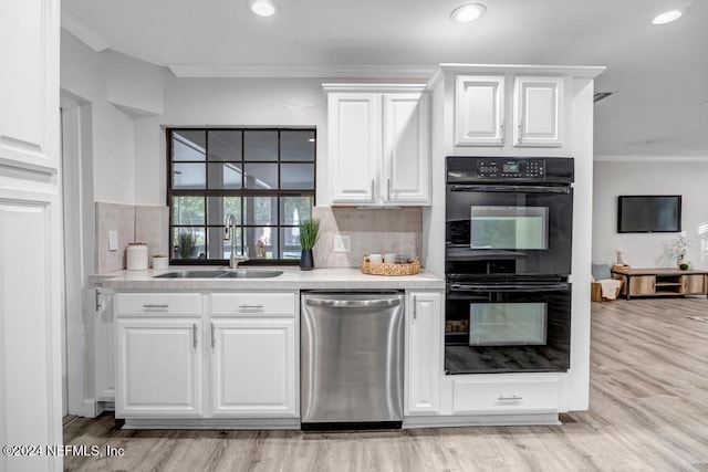 kitchen with white cabinetry, sink, stainless steel dishwasher, double oven, and crown molding