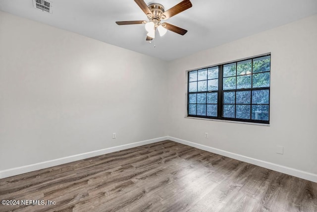 unfurnished room with hardwood / wood-style floors and ceiling fan