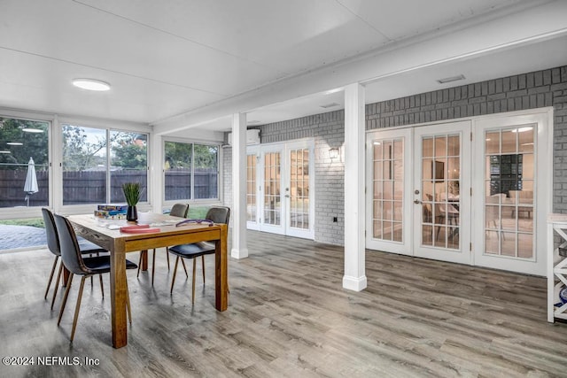 sunroom / solarium featuring french doors