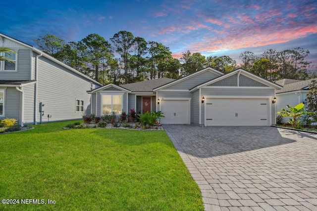 ranch-style home with a yard and a garage