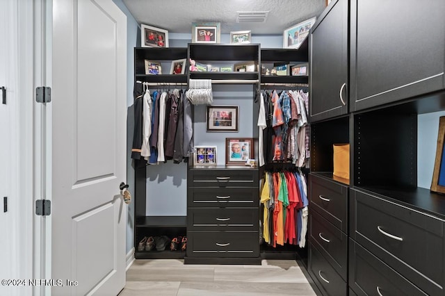 walk in closet featuring light wood-type flooring