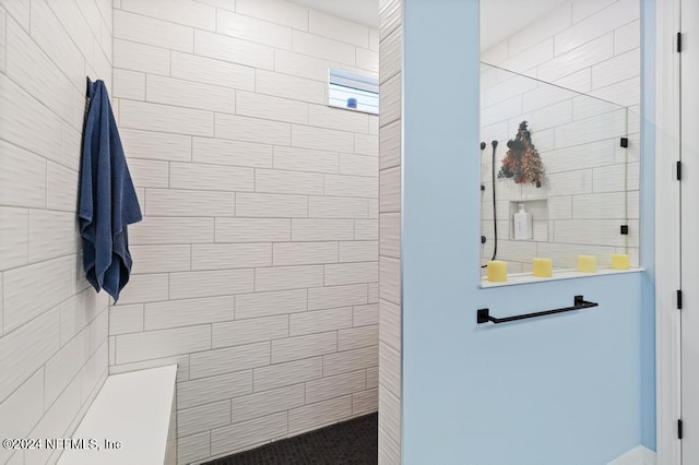 bathroom with tiled shower