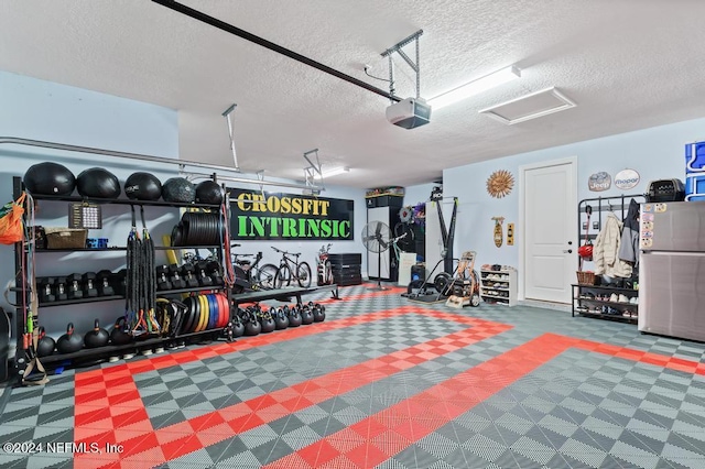 garage featuring stainless steel refrigerator and a garage door opener