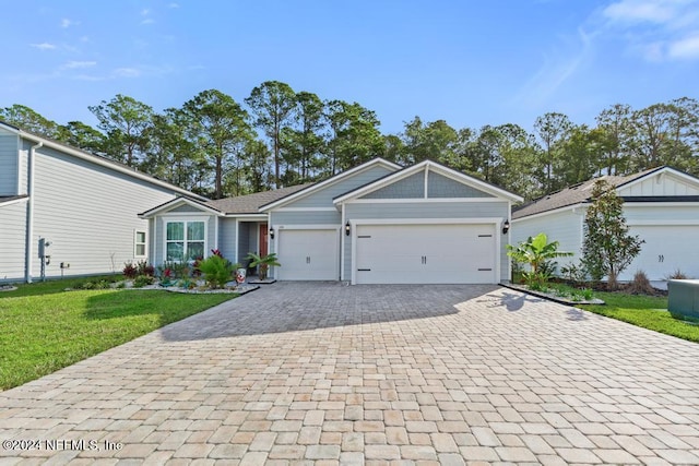 ranch-style home with a front lawn and a garage