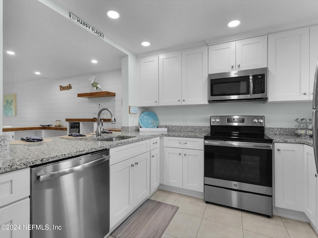 8550 A1A S Unit 13131, Saint Augustine, FL 32080 - kitchen with stainless steel appliances, a sink, white cabinetry, light tile patterned floors, and recessed lighting