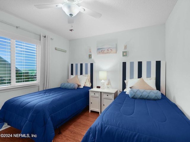 bedroom featuring dark hardwood / wood-style flooring and ceiling fan