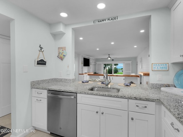 kitchen with light stone counters, dishwasher, white cabinetry, ceiling fan, and sink