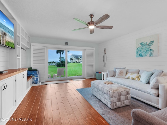 unfurnished living room featuring ceiling fan and light hardwood / wood-style flooring