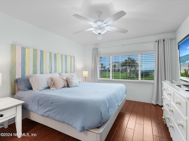 bedroom with ceiling fan and dark hardwood / wood-style floors