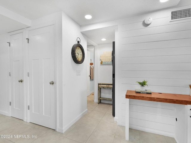 hallway featuring light tile patterned floors