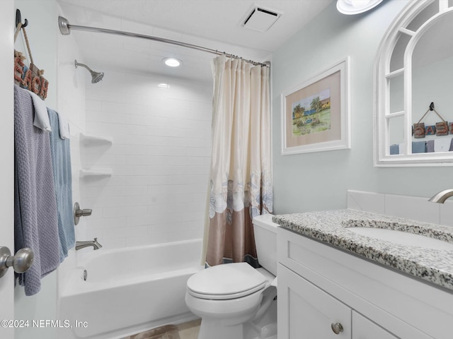 full bathroom with shower / tub combo with curtain, vanity, and toilet