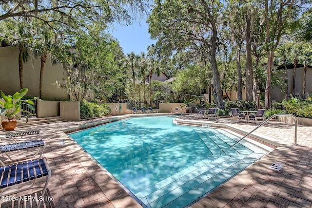 view of swimming pool with a patio